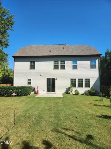 a house view with a sitting space and garden