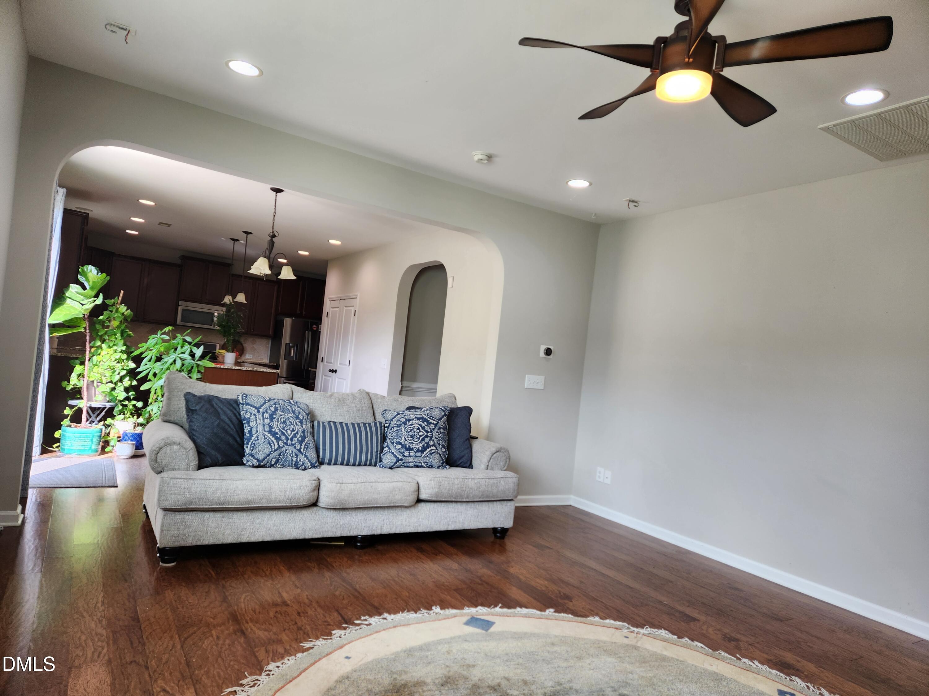 825 Wickham Ridge Road Apex, NC 27539 - Photo 5 of 31 a living room with furniture and a chandelier