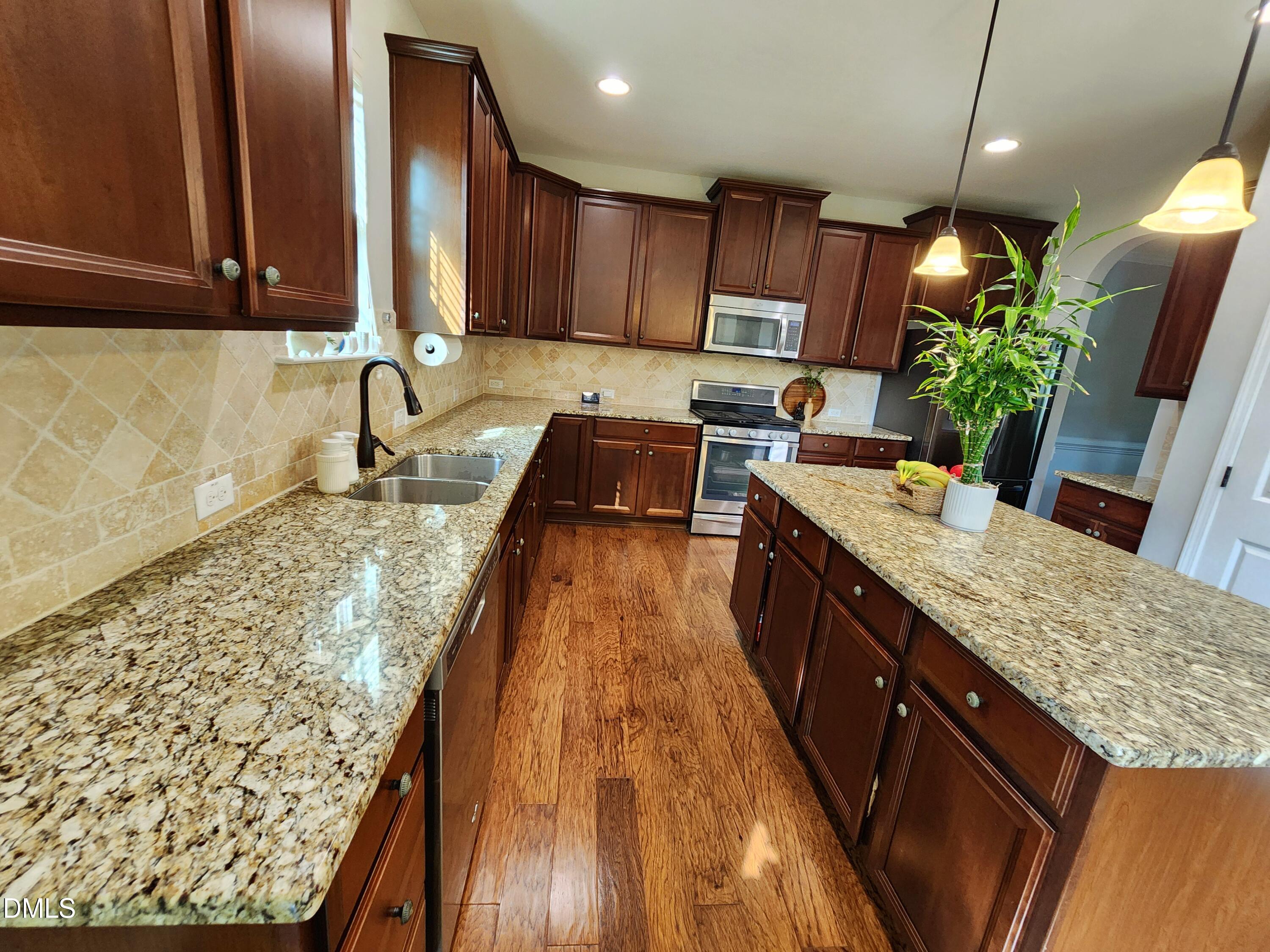 825 Wickham Ridge Road Apex, NC 27539 - Photo 8 of 31 a kitchen with granite countertop lots of counter top space