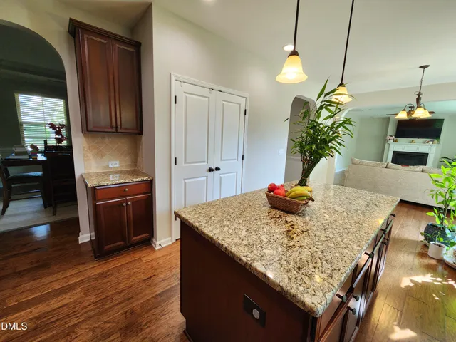 a kitchen with kitchen island granite countertop wooden cabinets and a granite counter tops