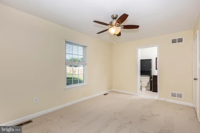 a view of a livingroom with a ceiling fan and window