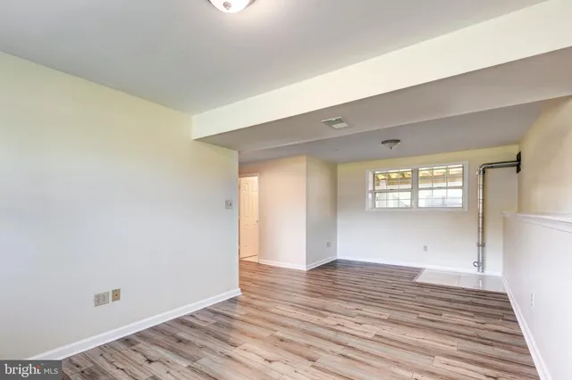 a view of a room with wooden floor and natural light