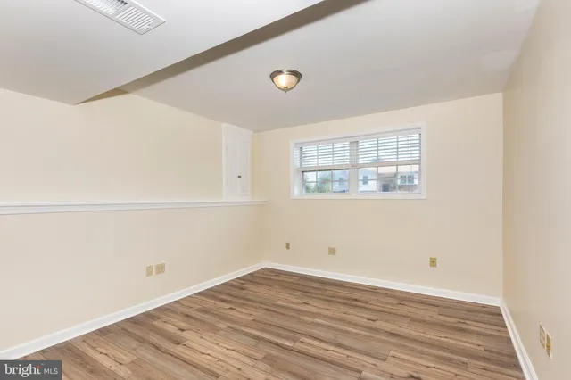 a view of a room with wooden floor