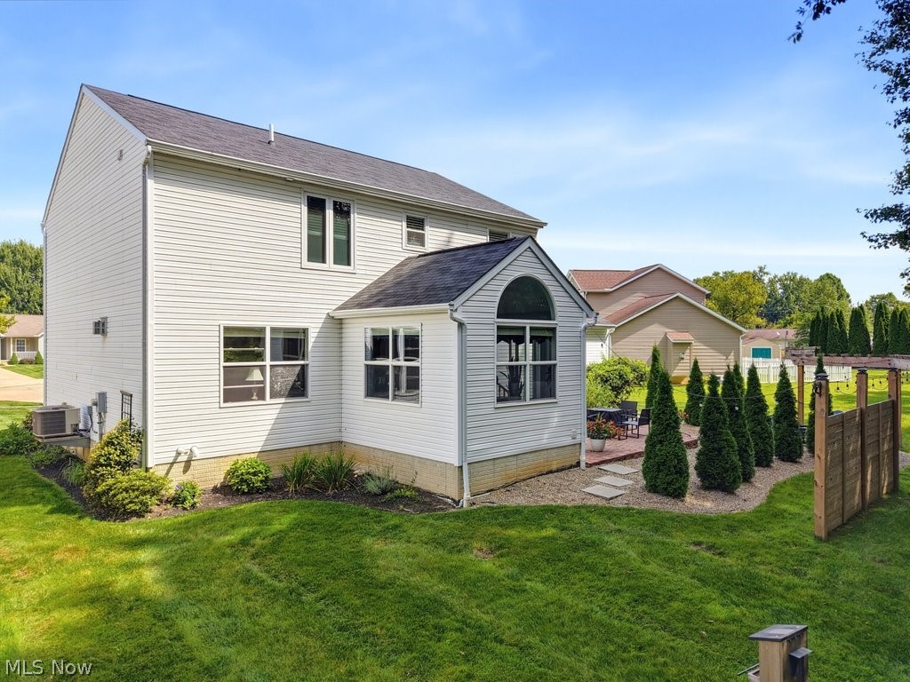 851 Susan Road Ravenna, OH 44266 - Photo 41 of 50 White vinyl siding exterior with an arched window accent