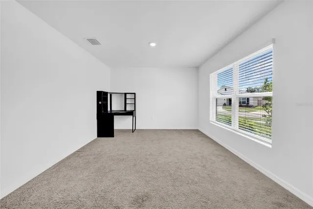 an empty room with windows and closet