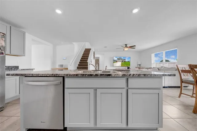 a kitchen with stainless steel appliances granite countertop a sink and cabinets