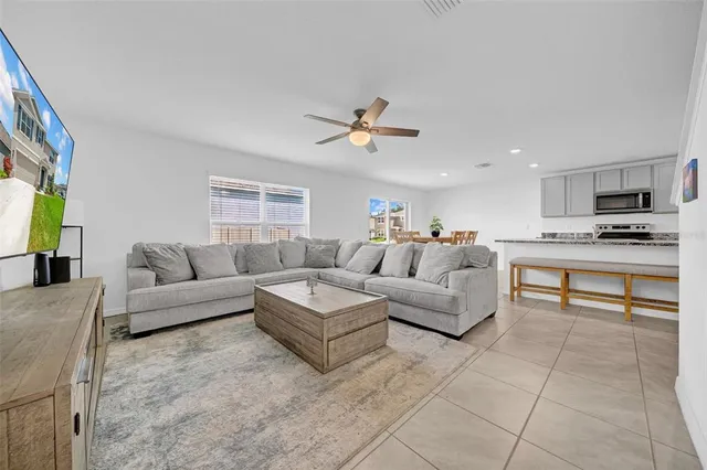 a living room with furniture and kitchen view