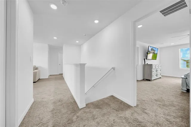 an entryway in a hall with a window and stairs