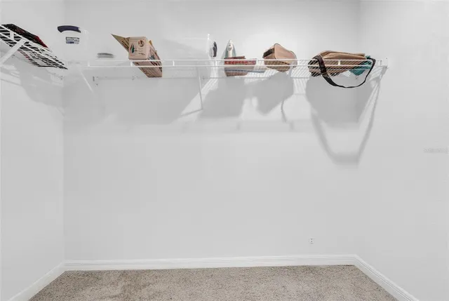 a white bath tub sitting next to a white wall