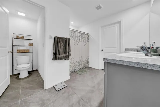 a bathroom with a sink toilet and a mirror