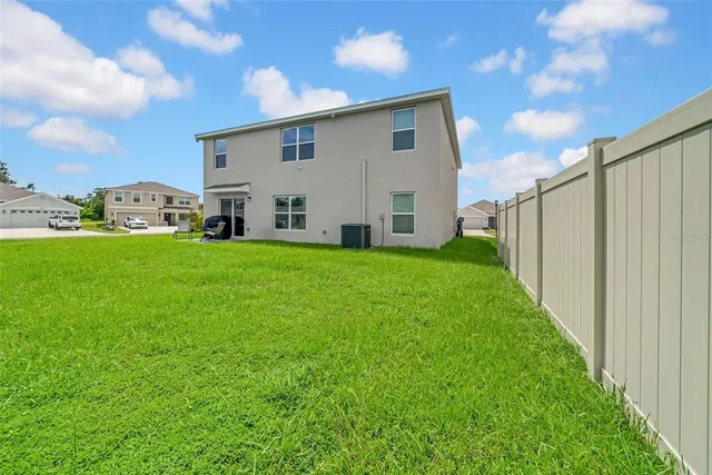 a view of a house with a backyard