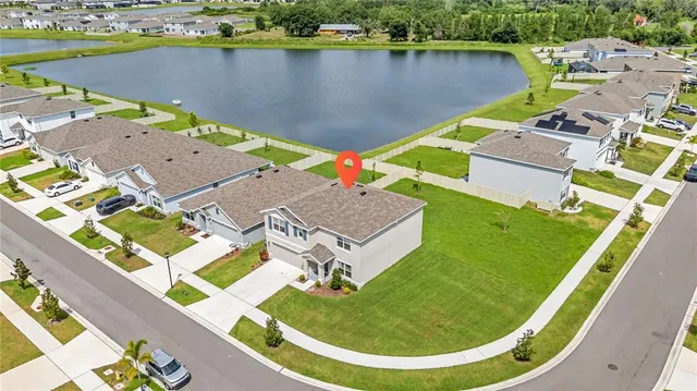 an aerial view of a house with a lake view
