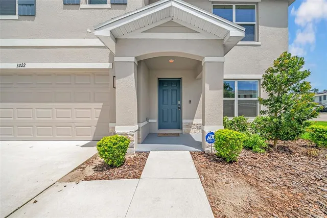 a front view of the house with potted plants