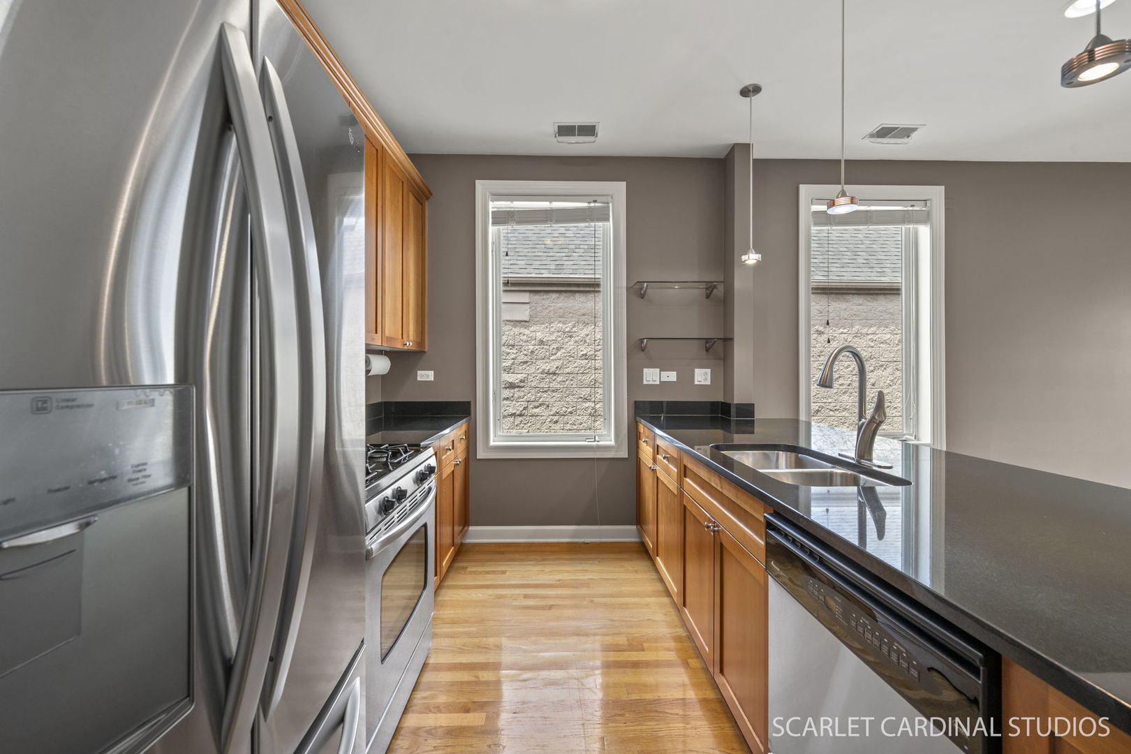 1419 West Fillmore Street, Unit 3W Chicago, IL 60607 - Photo 13 of 26 a kitchen with granite countertop a refrigerator and a sink