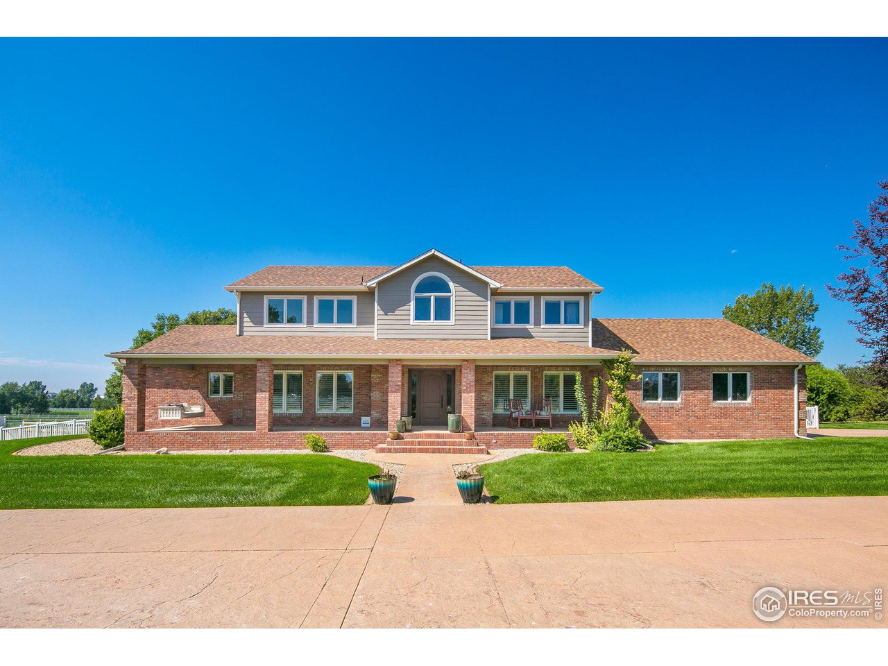 a view of big yard in front of house with a yard