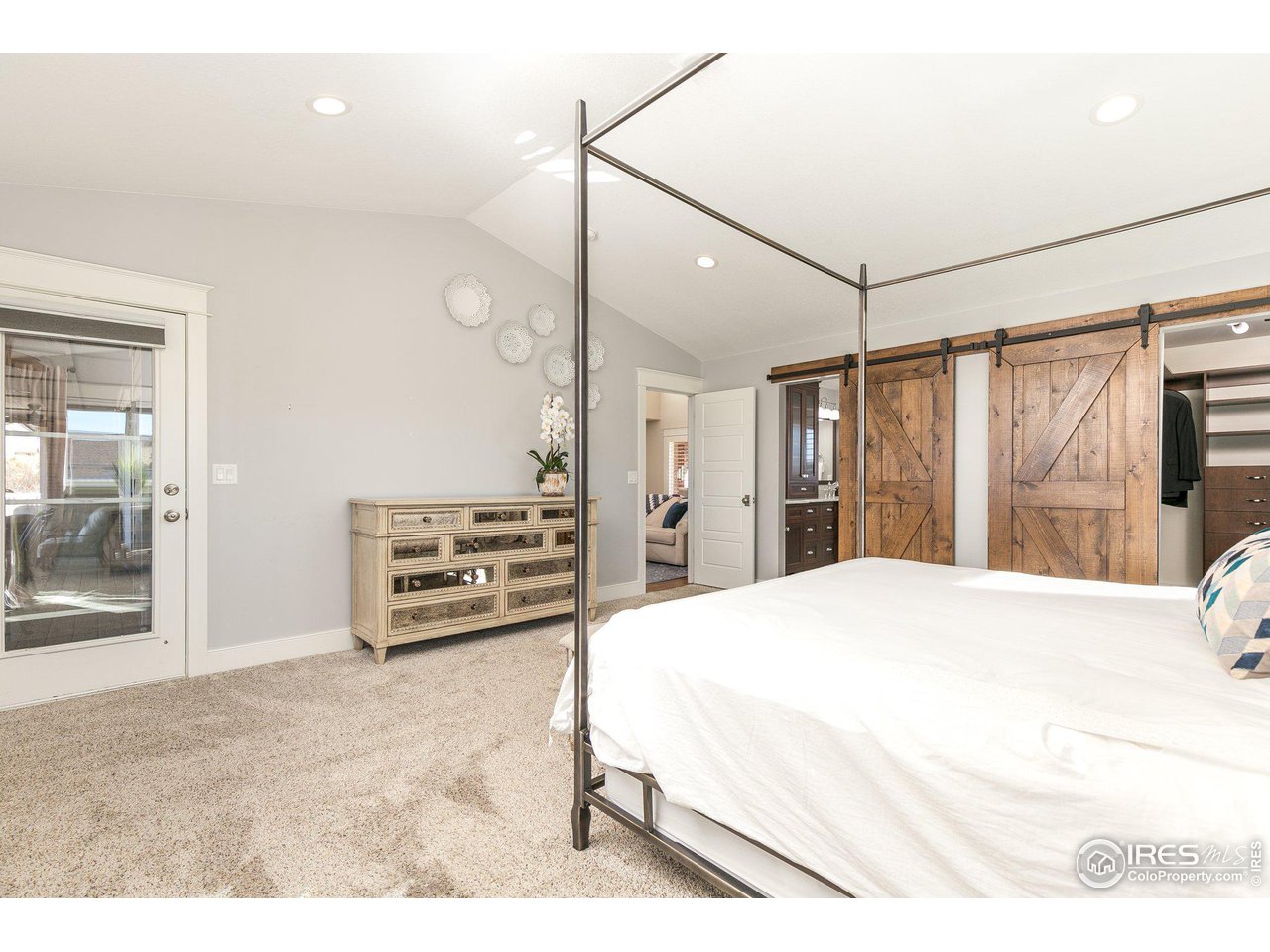 39337 Rangeview Drive Severance, CO 80610 - Photo 18 of 40 a spacious bedroom with a bed and a large mirror