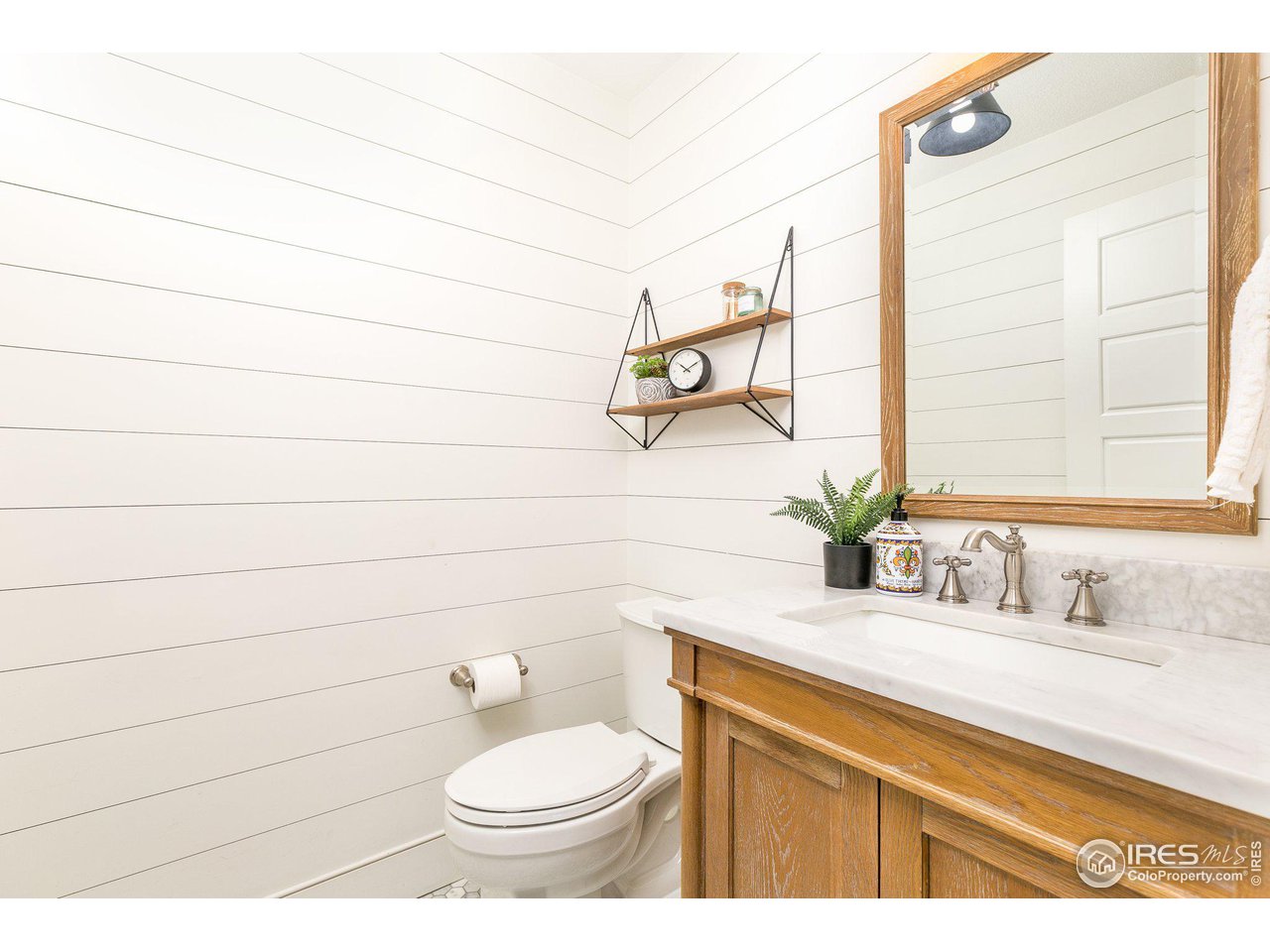 39337 Rangeview Drive Severance, CO 80610 - Photo 10 of 40 a bathroom with a sink a toilet and mirror