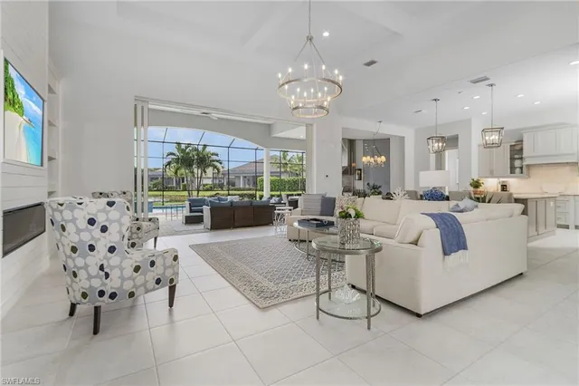 a living room with furniture a chandelier and a chandelier