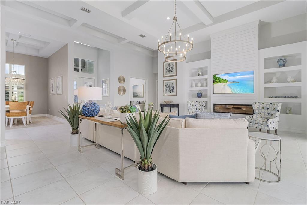 14226 Charthouse Circle Naples, FL 34114 - Photo 19 of 46 a living room with furniture a chandelier and a chandelier