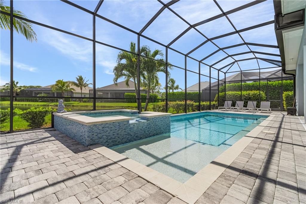 14226 Charthouse Circle Naples, FL 34114 - Photo 2 of 46 a view of swimming pool with a lounge chairs