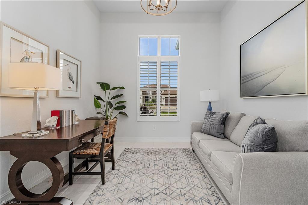 14226 Charthouse Circle Naples, FL 34114 - Photo 24 of 46 a living room with furniture and a window