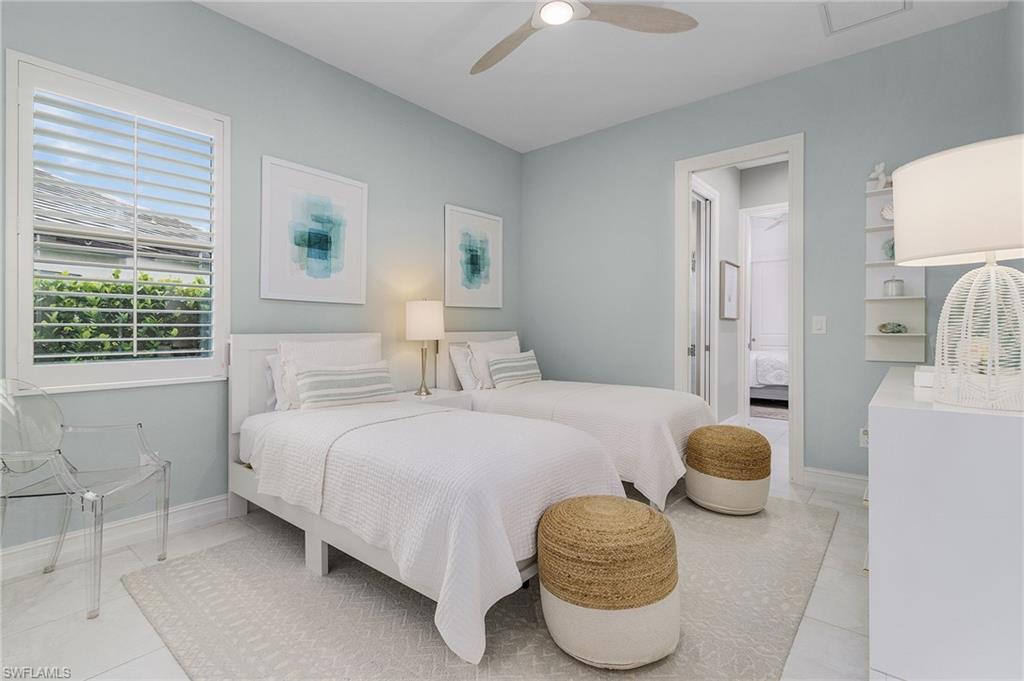 14226 Charthouse Circle Naples, FL 34114 - Photo 28 of 46 a bedroom with a bed and a window