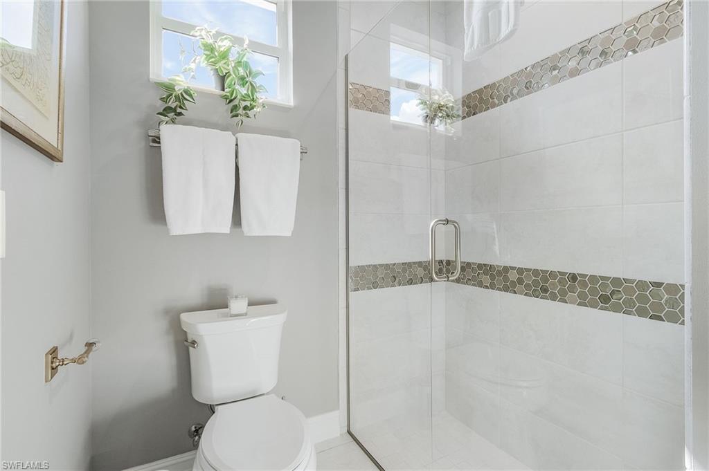 14226 Charthouse Circle Naples, FL 34114 - Photo 35 of 46 a bathroom with a toilet and a shower