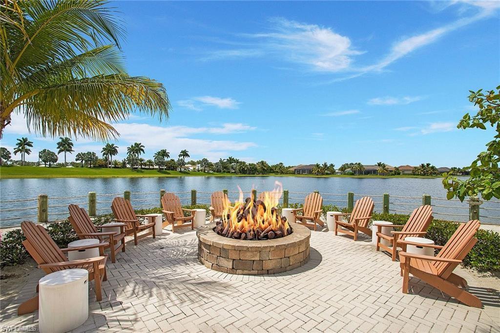 14226 Charthouse Circle Naples, FL 34114 - Photo 42 of 46 a view of a lake with couches chairs and a table