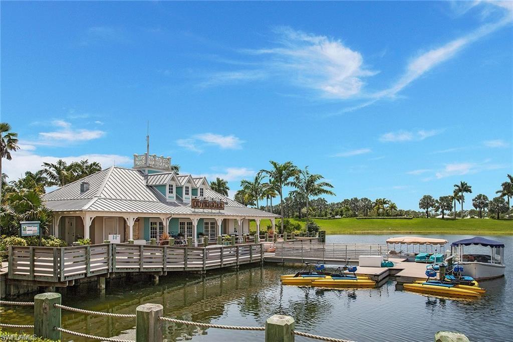 14226 Charthouse Circle Naples, FL 34114 - Photo 46 of 46 a view of a lake with a building in the background