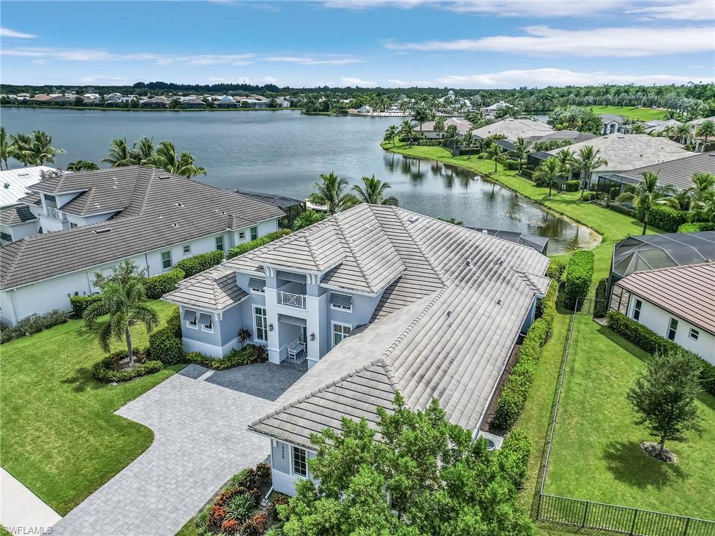 14226 Charthouse Circle Naples, FL 34114 - Photo 8 of 46 a view of a lake with a yard and large trees