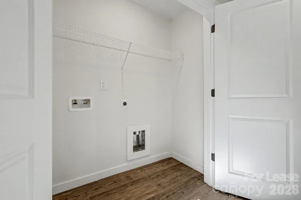 a view of a hallway with wooden floor and closet