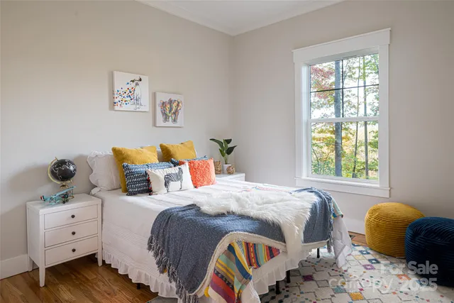 a bedroom with bed and a window