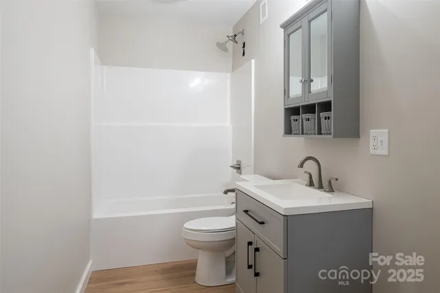a bathroom with a toilet a sink and bathtub