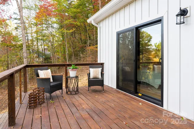 a balcony with chairs and wooden floor