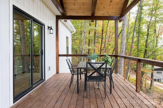 a view of a balcony with furniture and wooden floor