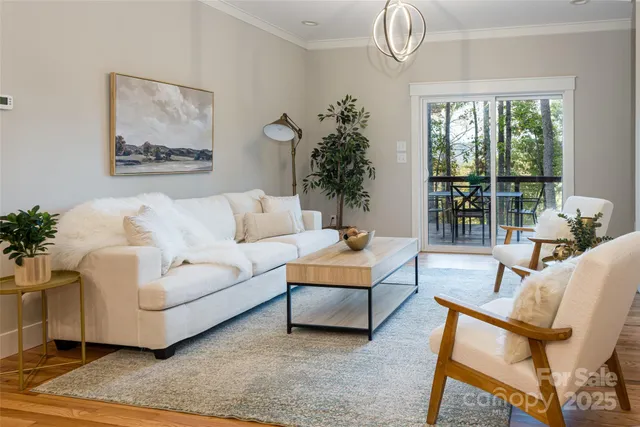a living room with furniture a chandelier and a chandelier