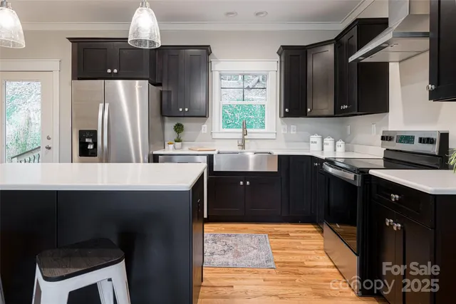 a kitchen with stainless steel appliances a sink stove and refrigerator