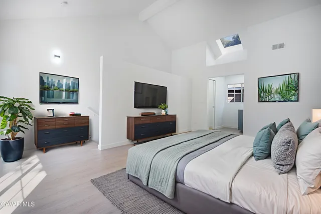 a bedroom with a bed and a television