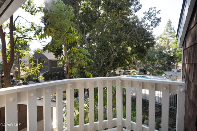 a wooden fence with trees in the background