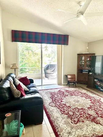 a living room with rug floor and a large window