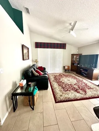 a living room with furniture and a rug