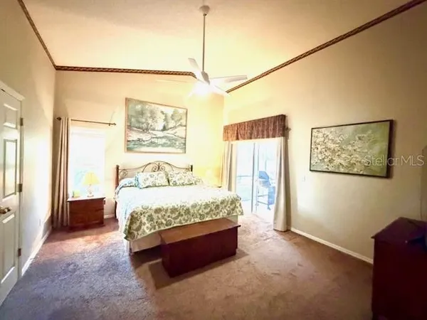 a large bed sitting in a bedroom next to a window