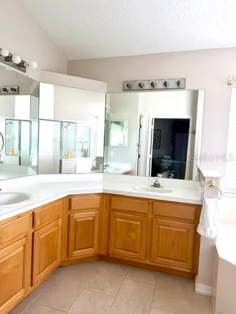 a large bathroom with a sink and mirror