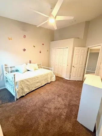 a bedroom with a bed and a couch