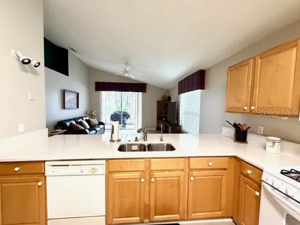 a kitchen with a sink cabinets and appliances