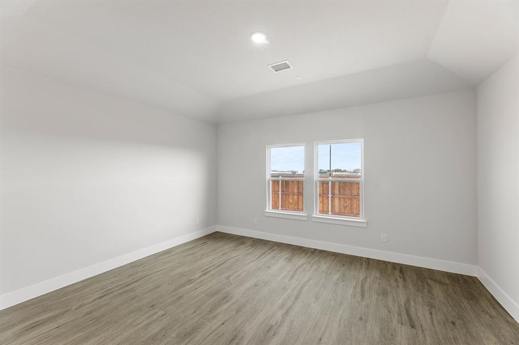 1504 Blackthorne Lane Krum, TX 76249 - Photo 13 of 30 an empty room with wooden floor and windows