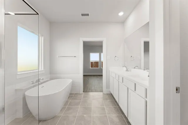 a bathroom with a bathtub and a sink