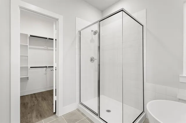 a bathroom with a shower and a sink