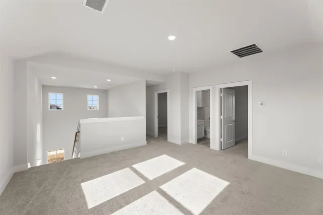 a view of a big room with closet and windows