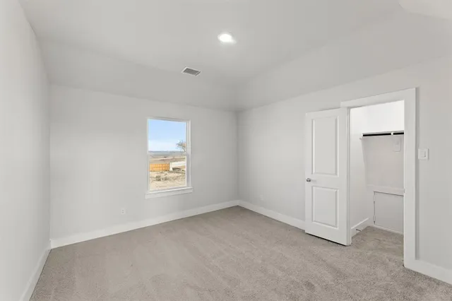 an empty room with windows and closet